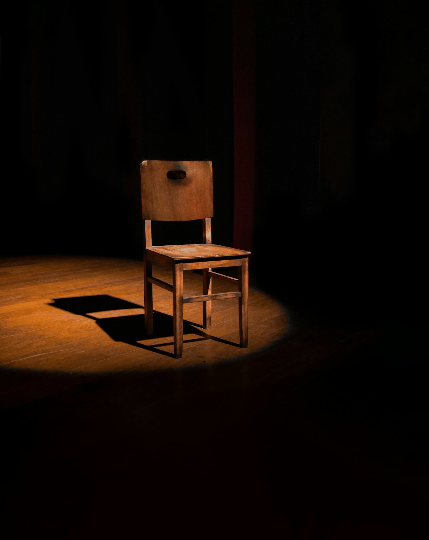 Handcrafted wooden chair under warm light